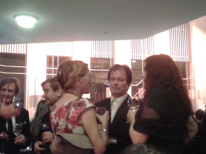 Författaren Kjell Westö samtalar med två damer.