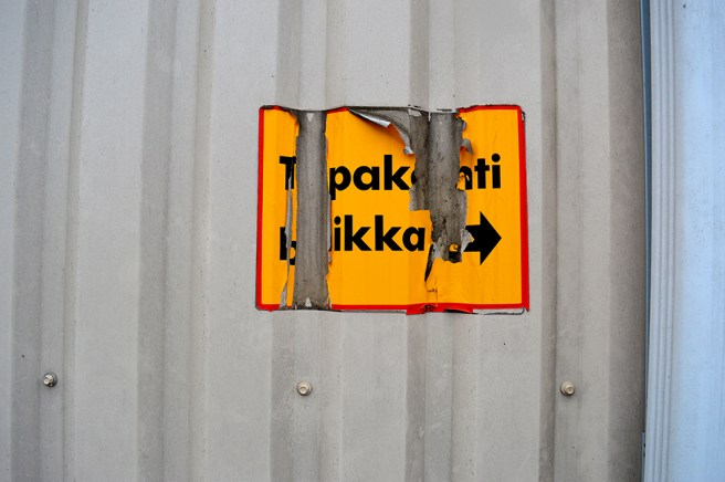 Tror att här ska stå Tupakointi paikka och pilen visar till höger. Plats för rökning bakom hörnet alltså.